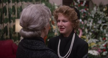 Movie still from “Mommie Dearest” (1981), directed by Frank Perry – A woman in a black jacket and a woman in a black jacket; Close Up shot, Over the shoulder angle