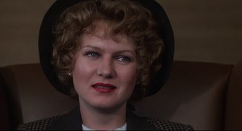 Movie still from “Mommie Dearest” (1981), directed by Frank Perry – A person wearing a hat; Close Up shot, Over the shoulder angle