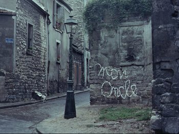 Movie still from “My Uncle” (1958), directed by Jacques Tati – A lamp post in the middle of an alleyway; Wide shot, High angle