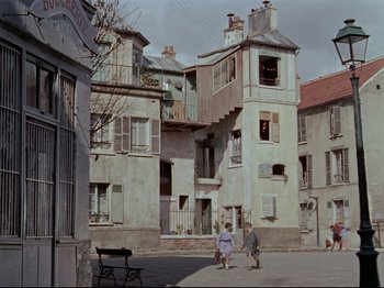 Movie still from “My Uncle” (1958), directed by Jacques Tati – Two children are walking down the street in a small town; Extreme Wide shot, High angle