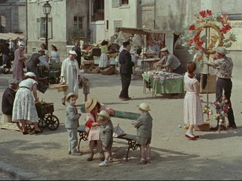 Movie still from “My Uncle” (1958), directed by Jacques Tati – A group of children playing in a market place; Wide shot, High angle