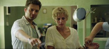 Movie still from “Monday” (2020), directed by Argyris Papadimitropoulos – A man and a woman in a room with a mirror; Medium shot, Over the shoulder angle