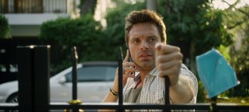 Movie still from “Monday” (2020), directed by Argyris Papadimitropoulos – A man is talking on a cell phone while looking at the camera; Close Up shot, Low angle