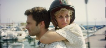 Movie still from “Monday” (2020), directed by Argyris Papadimitropoulos – A man and a woman wearing a motorcycle helmet; Close Up shot, Low angle