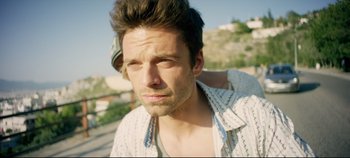 Movie still from “Monday” (2020), directed by Argyris Papadimitropoulos – A person wearing a hat; Close Up shot, Over the shoulder angle