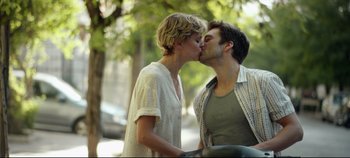 Movie still from “Monday” (2020), directed by Argyris Papadimitropoulos – A couple of people kissing on the street; Medium shot, Low angle