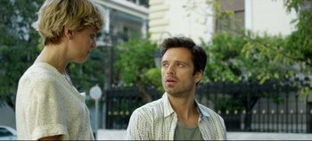 Movie still from “Monday” (2020), directed by Argyris Papadimitropoulos – Two men standing next to each other on the sidewalk; Close Up shot, Over the shoulder angle