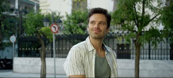 Movie still from “Monday” (2020), directed by Argyris Papadimitropoulos – A man standing in front of a street sign and trees; Close Up shot, Over the shoulder angle