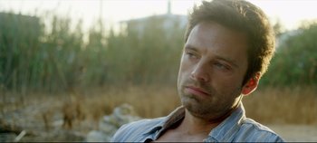 Movie still from “Monday” (2020), directed by Argyris Papadimitropoulos – A person wearing a blue shirt; Close Up shot, Over the shoulder angle