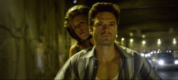Movie still from “Monday” (2020), directed by Argyris Papadimitropoulos – A man and a woman are standing in a dark alley; Close Up shot, Low angle