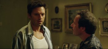 Movie still from “Monday” (2020), directed by Argyris Papadimitropoulos – A man standing next to another man in front of a mirror; Close Up shot, Over the shoulder angle