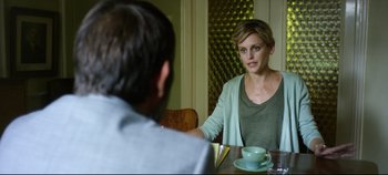 Movie still from “Monday” (2020), directed by Argyris Papadimitropoulos – A man and a woman sitting at a dining table; Medium shot, Over the shoulder angle