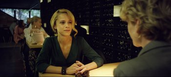 Movie still from “Monday” (2020), directed by Argyris Papadimitropoulos – A woman sitting at a table in front of a man; Close Up shot, Over the shoulder angle