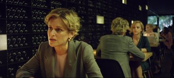 Movie still from “Monday” (2020), directed by Argyris Papadimitropoulos – A woman sitting in front of another woman in a room; Close Up shot, Over the shoulder angle