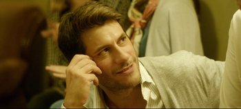 Movie still from “Monday” (2020), directed by Argyris Papadimitropoulos – A person wearing a shirt and tie; Close Up shot, Over the shoulder angle