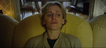 Movie still from “Monday” (2020), directed by Argyris Papadimitropoulos – A woman sitting in a chair with her eyes wide open; Close Up shot, High angle