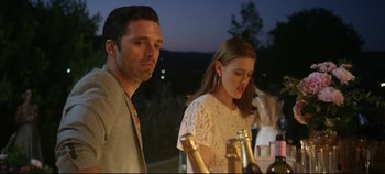 Movie still from “Monday” (2020), directed by Argyris Papadimitropoulos – A man and a woman standing next to each other at an event; Close Up shot, Over the shoulder angle
