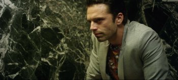 Movie still from “Monday” (2020), directed by Argyris Papadimitropoulos – A person wearing a suit and tie; Close Up shot, Overhead angle