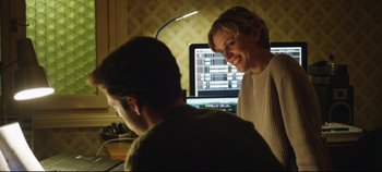 Movie still from “Monday” (2020), directed by Argyris Papadimitropoulos – A woman and a man sitting in front of computer screens; Medium shot, Over the shoulder angle