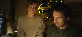 Movie still from “Monday” (2020), directed by Argyris Papadimitropoulos – A woman standing next to a man in front of lights; Medium shot, Low angle