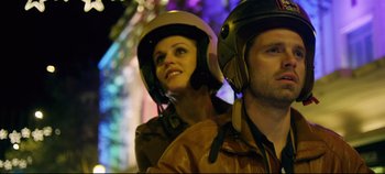 Movie still from “Monday” (2020), directed by Argyris Papadimitropoulos – A man and a woman wearing motorcycle helmets; Close Up shot, Low angle