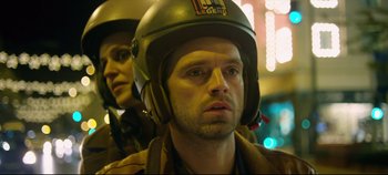 Movie still from “Monday” (2020), directed by Argyris Papadimitropoulos – A man and a woman wearing a helmet; Close Up shot, Low angle