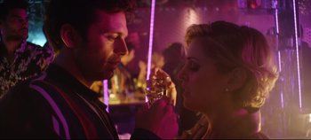 Movie still from “Monday” (2020), directed by Argyris Papadimitropoulos – A man and a woman holding a wine glass in their hands; Close Up shot, Over the shoulder angle