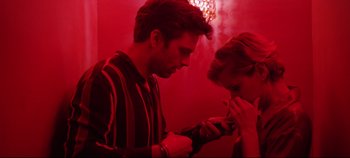 Movie still from “Monday” (2020), directed by Argyris Papadimitropoulos – A man and a woman looking at a cell phone; Close Up shot, Low angle