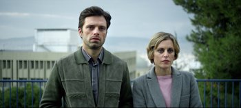 Movie still from “Monday” (2020), directed by Argyris Papadimitropoulos – A man and a woman standing next to each other; Medium shot, Low angle