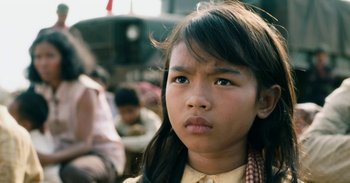 Movie still from “First They Killed My Father” (2017), directed by Angelina Jolie – A young girl is looking into the distance; Close Up shot, Over the shoulder angle