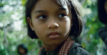 Movie still from “First They Killed My Father” (2017), directed by Angelina Jolie – A young girl's face; Close Up shot, High angle