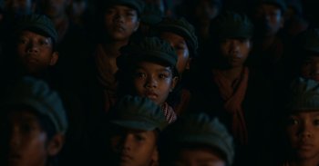 Movie still from “First They Killed My Father” (2017), directed by Angelina Jolie – A group of young people wearing hats and looking at the camera; Close Up shot, High angle