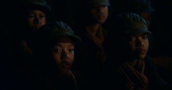 Movie still from “First They Killed My Father” (2017), directed by Angelina Jolie – A group of young people in a dark room; Close Up shot, Over the shoulder angle