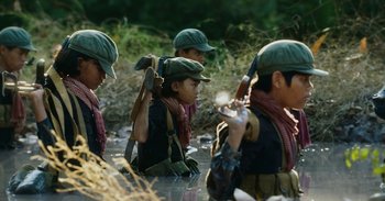 Movie still from “First They Killed My Father” (2017), directed by Angelina Jolie – A group of people in a body of water; Medium shot, High angle