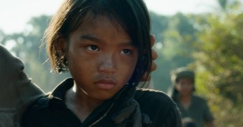 Movie still from “First They Killed My Father” (2017), directed by Angelina Jolie – A young girl's face; Close Up shot, Over the shoulder angle