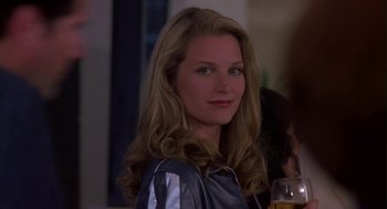 Movie still from “Monkeybone” (2001), directed by Henry Selick – A woman with long blonde hair is holding a glass of beer; Close Up shot, Over the shoulder angle