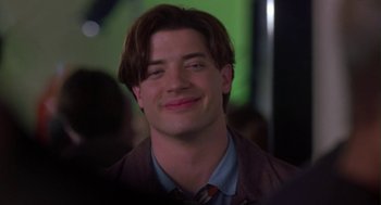 Movie still from “Monkeybone” (2001), directed by Henry Selick – A person wearing a suit and tie smiling; Close Up shot, Low angle