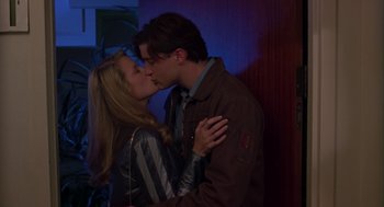 Movie still from “Monkeybone” (2001), directed by Henry Selick – A man and a woman kissing each other in front of a wall; Medium shot, Low angle