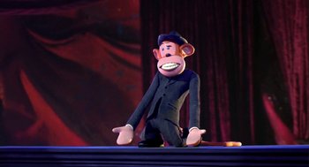Movie still from “Monkeybone” (2001), directed by Henry Selick – A toy monkey sitting on the ground on a stage; Medium shot, Low angle