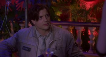 Movie still from “Monkeybone” (2001), directed by Henry Selick – A man in a jacket and tie sitting at a table; Close Up shot, Over the shoulder angle