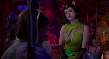 Movie still from “Monkeybone” (2001), directed by Henry Selick – A woman dressed as a cat in a green dress; Medium shot, Over the shoulder angle