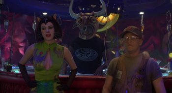 Movie still from “Monkeybone” (2001), directed by Henry Selick – A man and a woman standing next to a statue of a bull; Medium shot, Over the shoulder angle