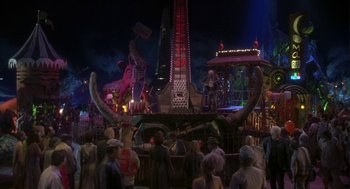 Movie still from “Monkeybone” (2001), directed by Henry Selick – A group of people standing around a carnival ride; Extreme Wide shot, High angle