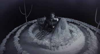 Movie still from “Monkeybone” (2001), directed by Henry Selick – A black and white photo of a bride and groom; Wide shot, High angle