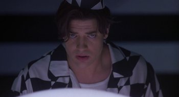 Movie still from “Monkeybone” (2001), directed by Henry Selick – A man in a checkerboard jacket looking at the camera; Close Up shot, Low angle