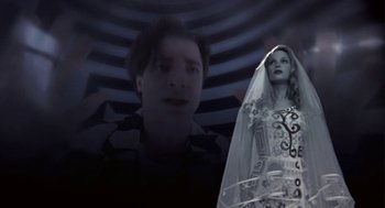 Movie still from “Monkeybone” (2001), directed by Henry Selick – A man and a woman in a black and white photo; Medium shot, Low angle