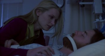 Movie still from “Monkeybone” (2001), directed by Henry Selick – A woman is looking at a man laying in a hospital bed; Close Up shot, Over the shoulder angle