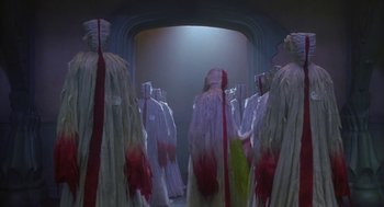 Movie still from “Monkeybone” (2001), directed by Henry Selick – A group of people dressed in white and red robes; Wide shot, Low angle