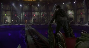 Movie still from “Monkeybone” (2001), directed by Henry Selick – A man standing next to a train track at night; Wide shot, High angle