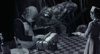 Movie still from “Monkeybone” (2001), directed by Henry Selick – An old photo of an old man playing a game with an alien; Medium shot, High angle